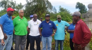 Minister Holder, Permanent Secretary of teh Ministry of Agriculture George Jervis, GLDA CEO and NAREI CEO and other officials while speaking to a farmer during the outreach