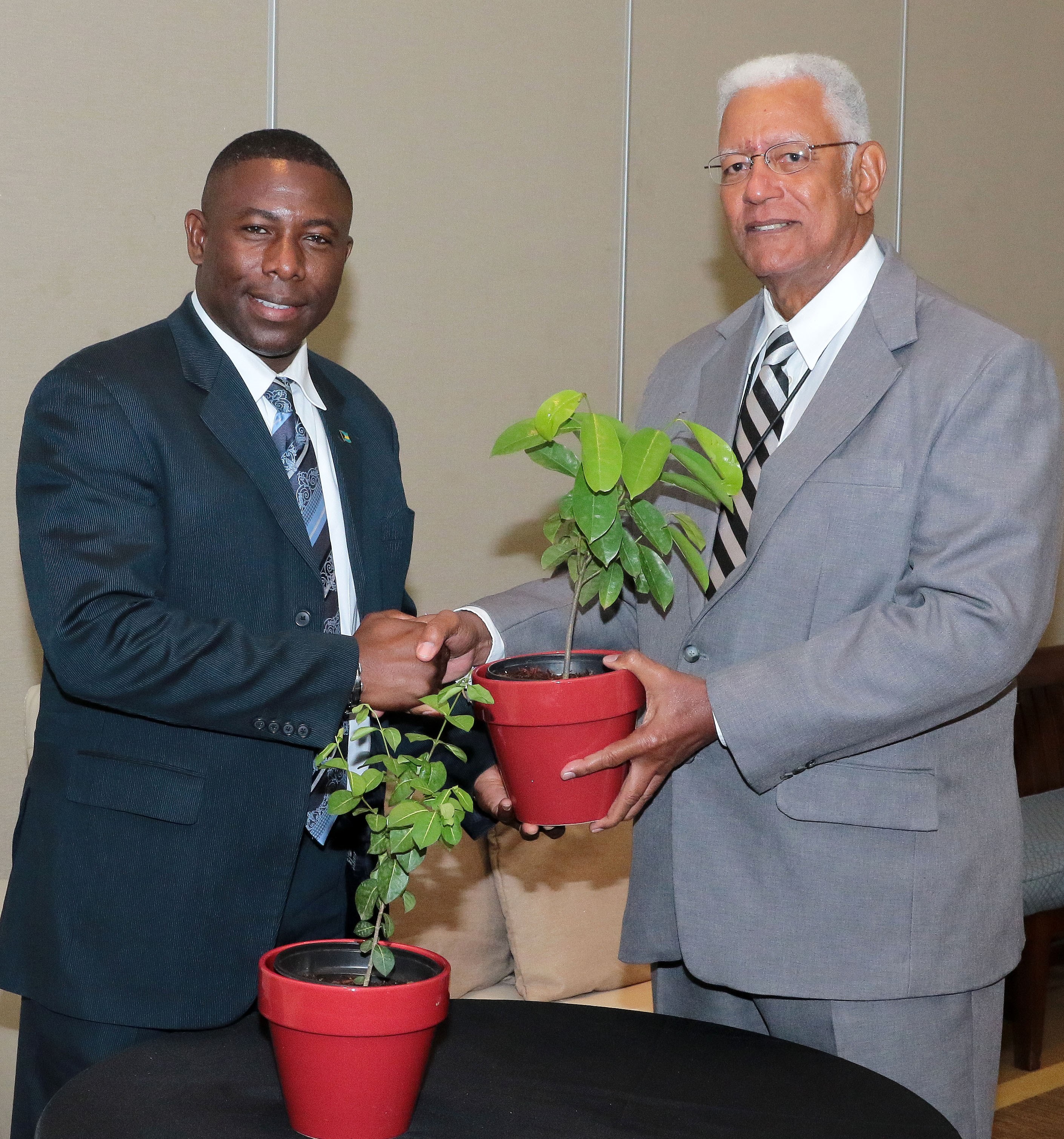 Agriculture Minister Hon. Noel Holder hands over the donated plants to the Hon. Renward Wells, Minister of Agriculture and Marine Resources, Bahamas