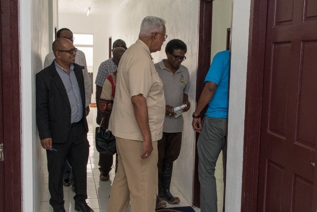 Minister of Agriculture, Noel Holder, is given a tour of the Facility by CEO of the NDIA, Fredrick Flatts.