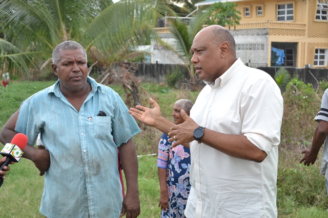 Minister of Natural Resources, Hon. Raphael Trotman speaking with resident Lloyd Alphonso