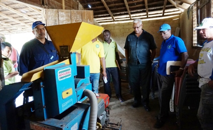 Minister of Agriculture Noel Holder and other officials examine rice milling machine during visit in region 8