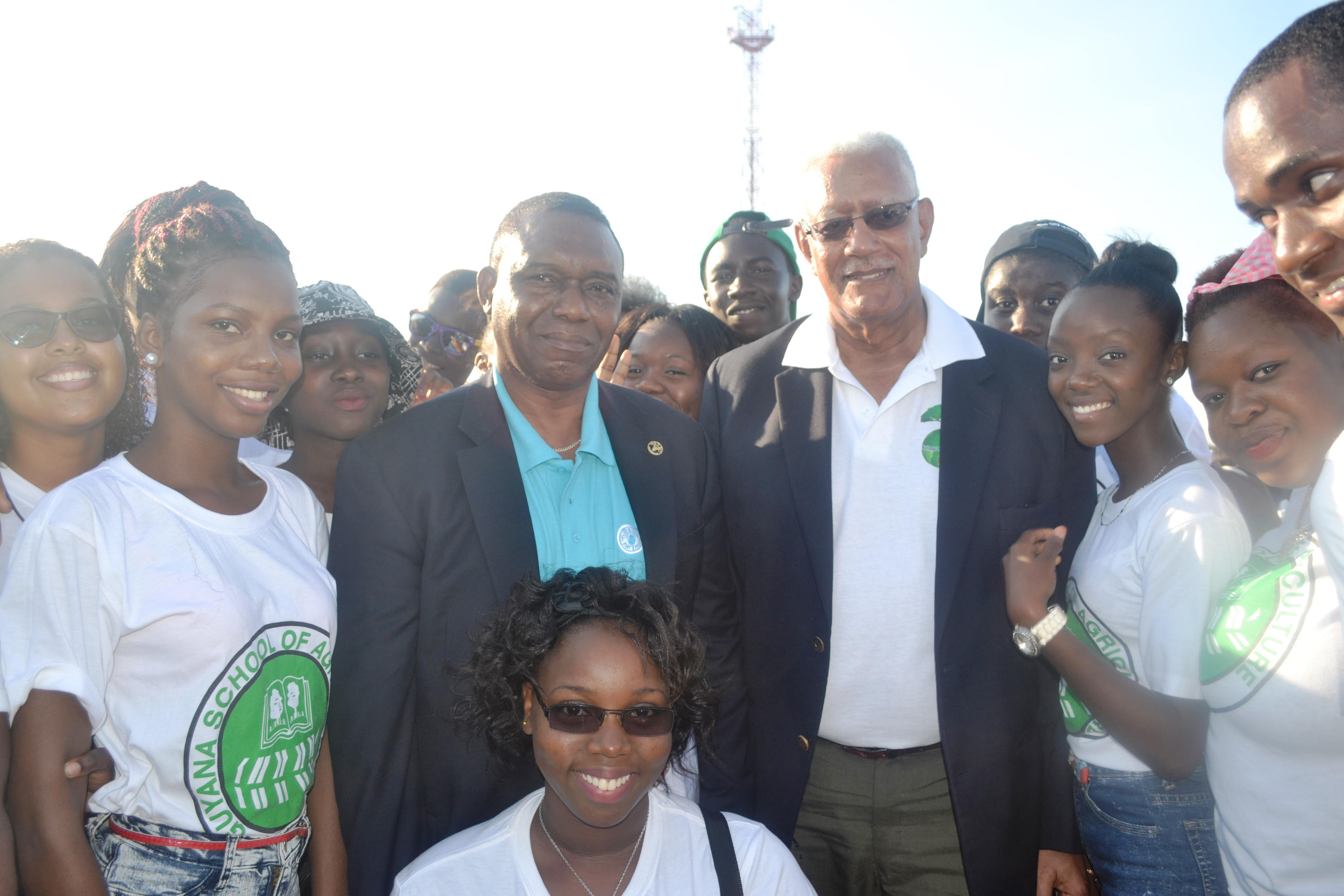 Agriculture Minister, Noel Holder  and FAO country representative with GSA students at the World Food Day  fair