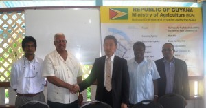 Agriculture Minister Noel Holder shakes hands with Japanese Ambassador H.E. Mitsuhiko Okada during a handing over ceremony of the Rehabilitation of the EDWC II. Theyare accompanied by other NDIA reps