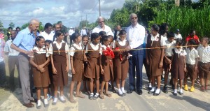 H.E. President Granger accompanied by Ministers of  Agriculture and Communities during the cutting of teh ribbon for one of the  commissioned access roads