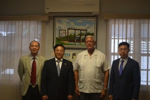 Agriculture Minister Noel Holder and China's Ambassador H.E Cui Jianchun (center) flanked by Political and Commercial Councilors respectively