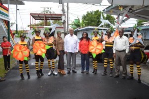 Designer of Ministry of Agriculture’s Mash float and costumes, Carol Fraser with Minister of Agriculture, Noel Holder, staff and revellers displaying the costumes