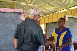 Agriculture Minister, Noel Holder while meeting Head Teacher for Baracara Primary School, Ms Kim Sampson