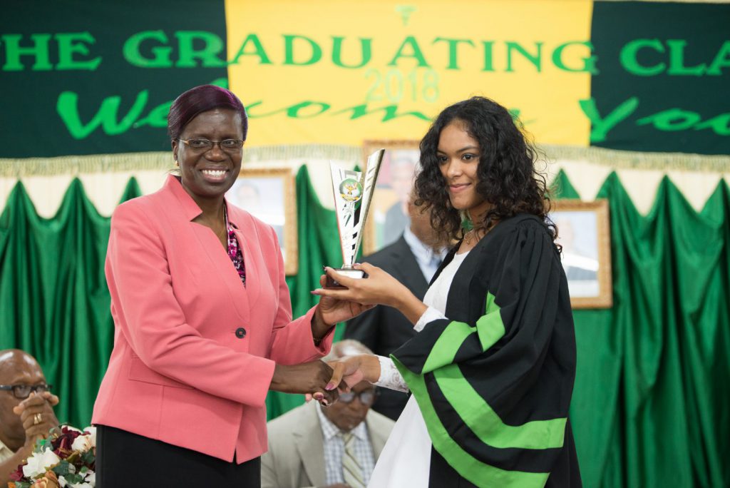 Permanent Secretary of the Ministry of Agriculture, Delma Nedd presents the trophy for ‘Best overall performance’ in the Agriculture Diploma Course to Alleema Shahabudeen