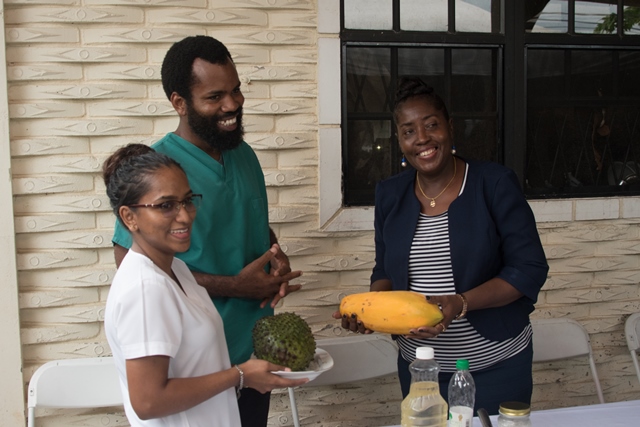 Dr. Allen, and his wife Rehana Fareed presenting Minister within the Ministry of Agriculture, Valerie Adam-Yearwood with fruit from their kitchen garden